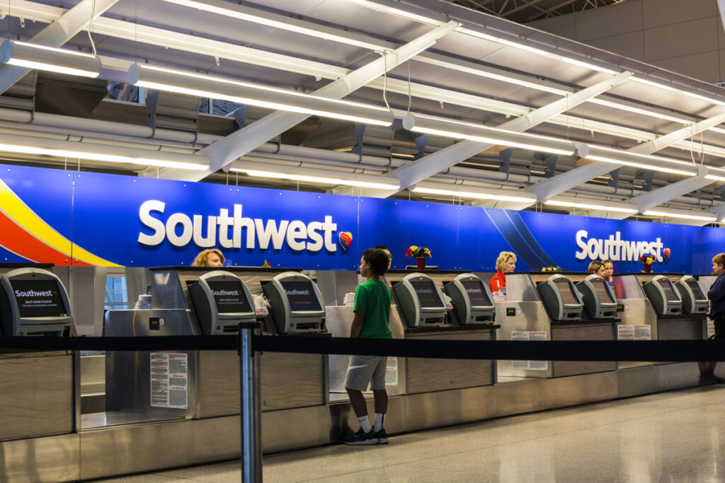 Southwest Airlines check-in desk preparing passengers for departure - class action