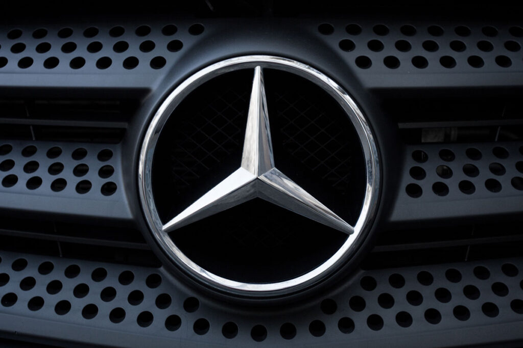 Close up of Mercedes emblem on front bumper.