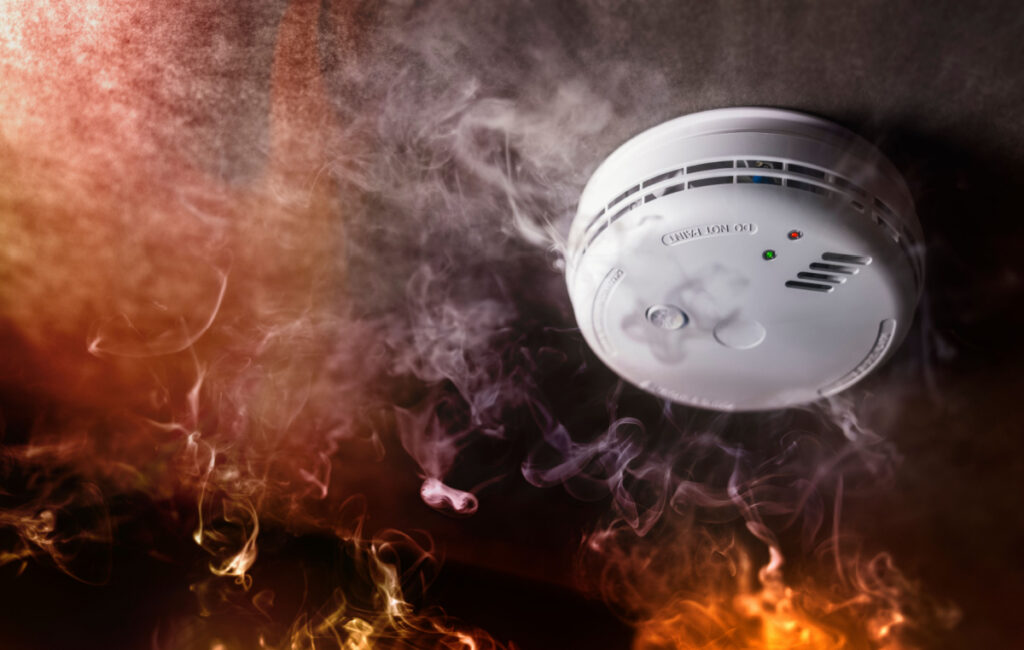 Smoke alarm surrounded by smoke