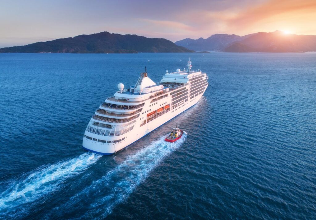 Aerial view of beautiful large white cruise at sunset, representing the FDA's warning to American Cruise Lines regarding Legionnaires' disease.