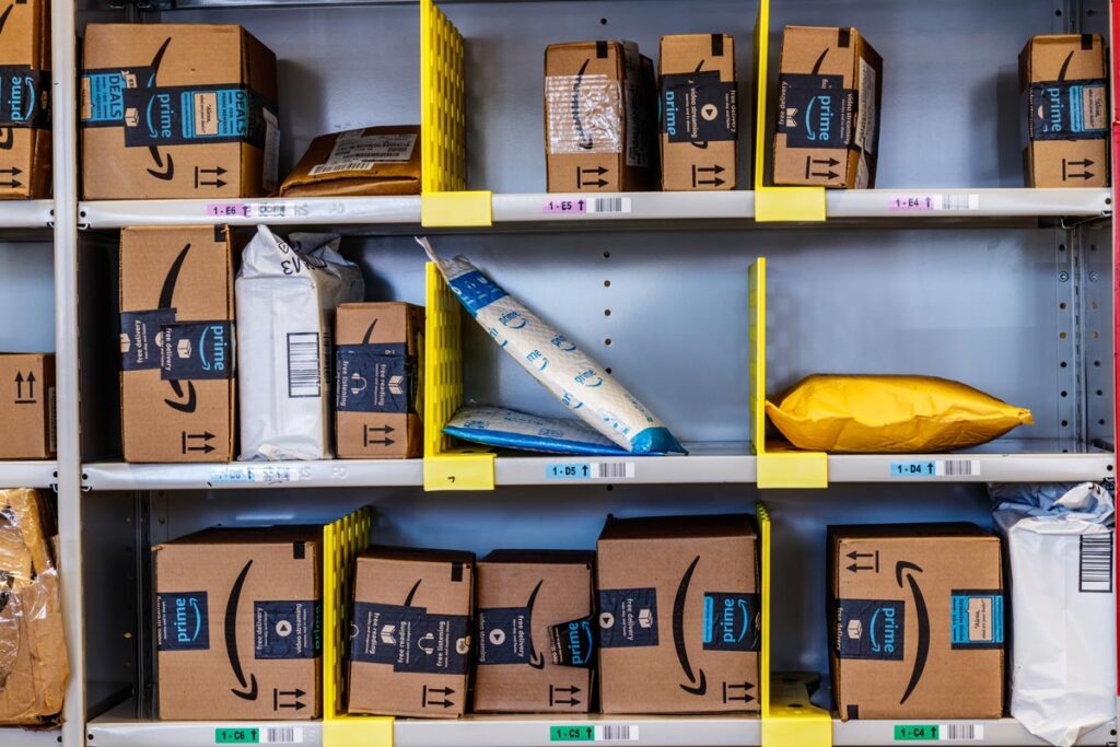 Close up of Amazon packages in a shelving unit.