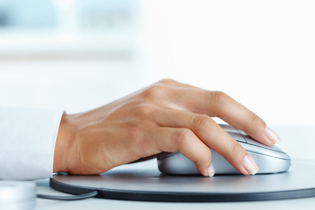 Close up of a female hand using a computer mouse, representing the Henri's Cloud Nine website class action.