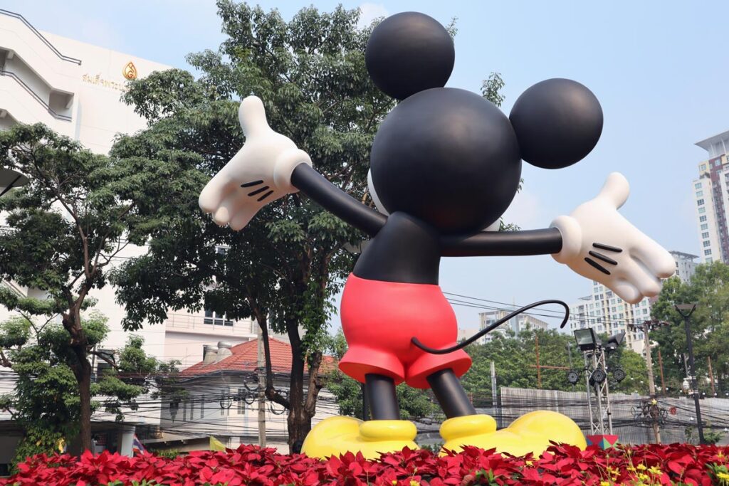 Back view of a Mickey Mouse status inside of a park, representing the Disney discrimination lawsuit.
