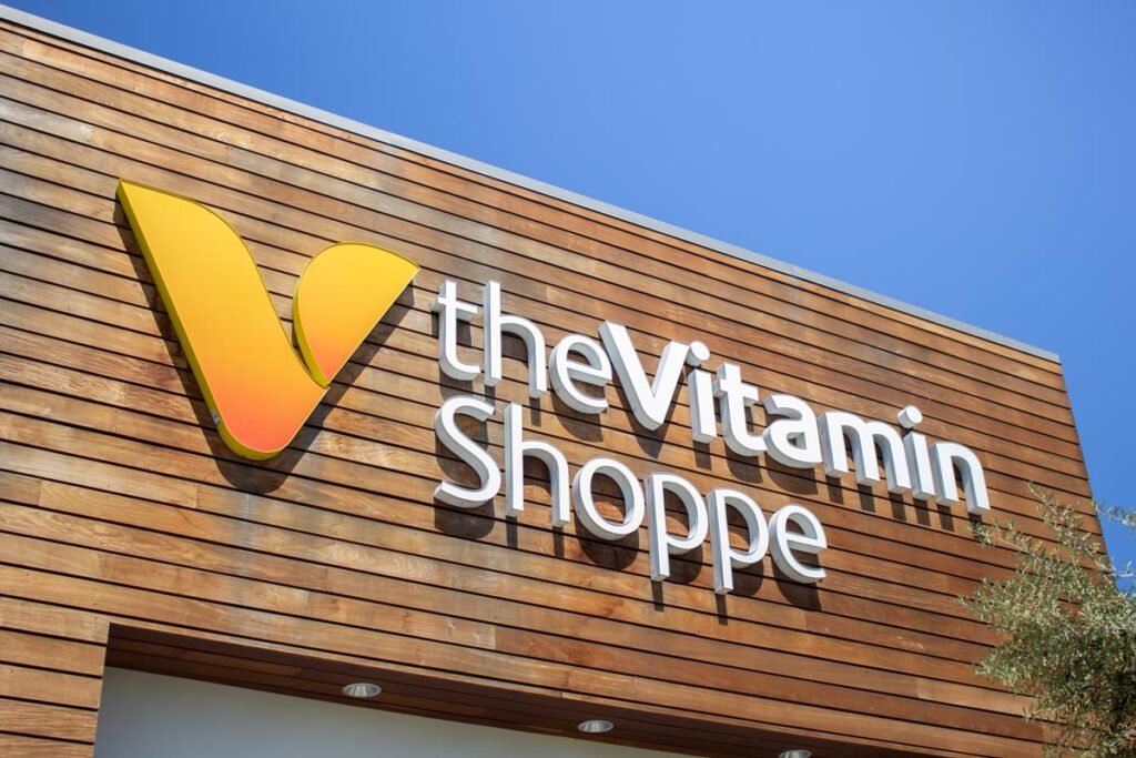 A store front sign for the vitamin and supplement general store known as The Vitamin Shoppe.