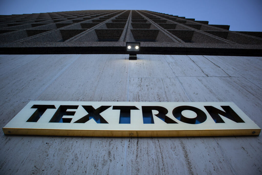 An upward view of the exterior of the Textron World Headquarters building, representing the PTV recall.