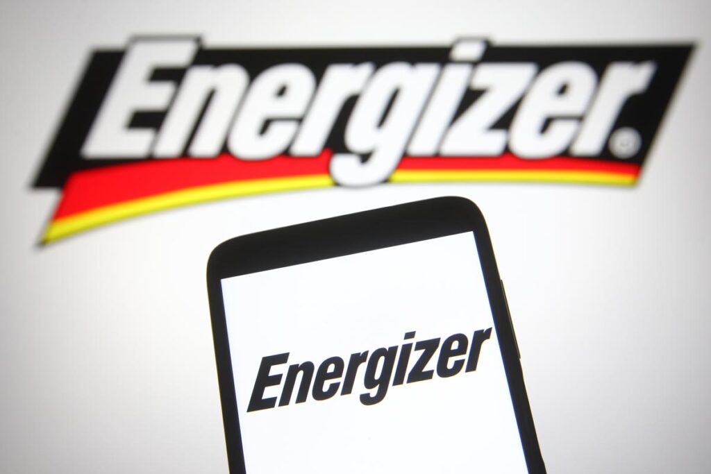 Energizer logo on a smartphone screen and in the background, representing the Energizer portable charger class action lawsuit.