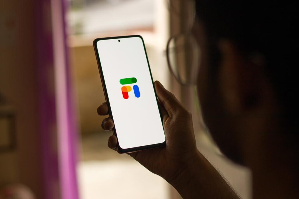 Close up of a girl using her smartphone with the Google Fi logo displayed.
