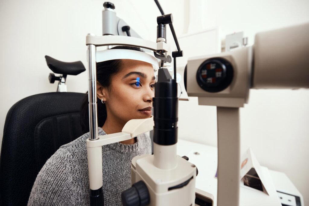 A young girl completing an eye test at a doctors office, representing the 20/20 Eye Care Network and Hearing Care Network data breach class action settlement.