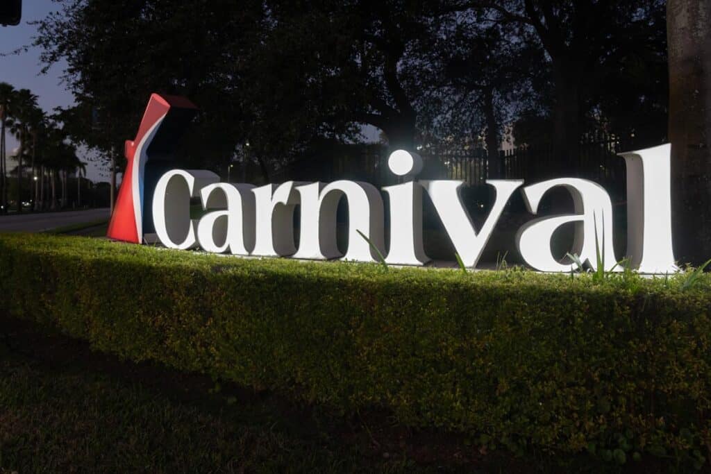 Carnival logo sign in the night at their headquarters in Miami, Florida.