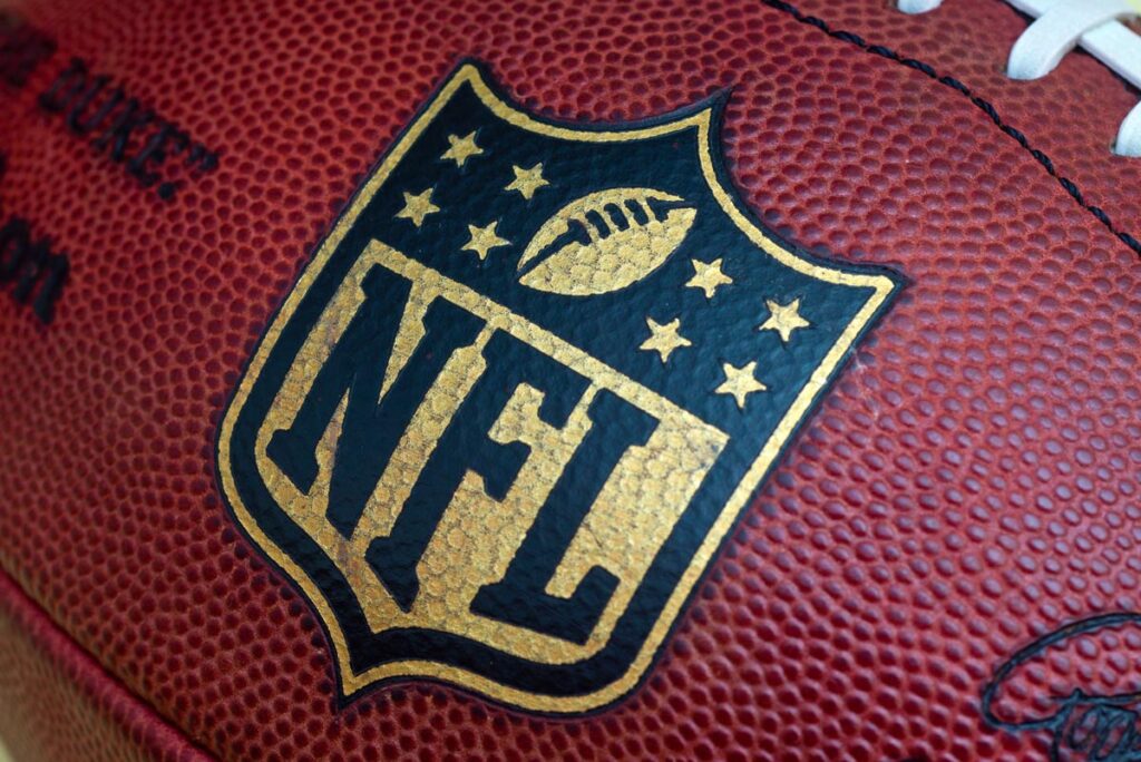 Close up of the NFL logo on a football.