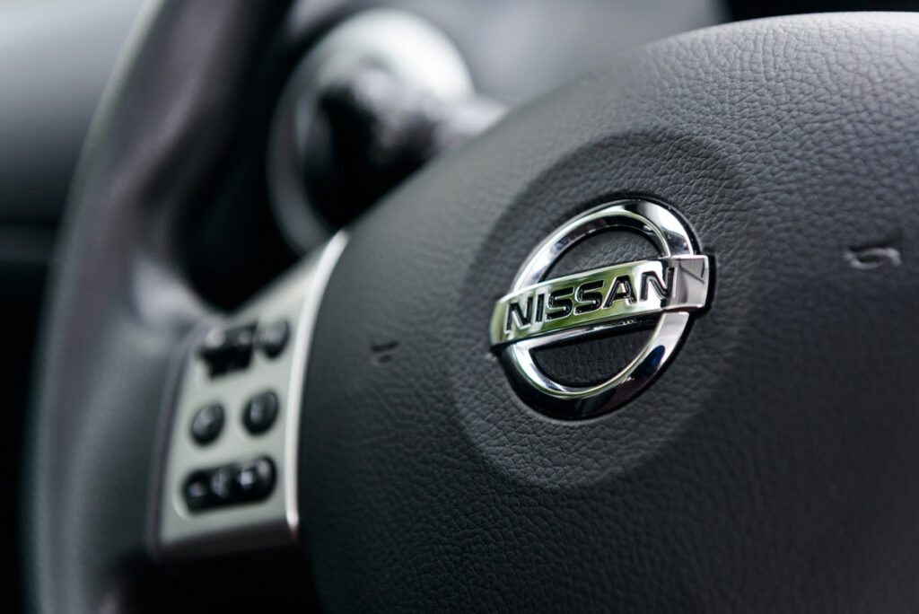 Close up of Nissan logo on a steering wheel.
