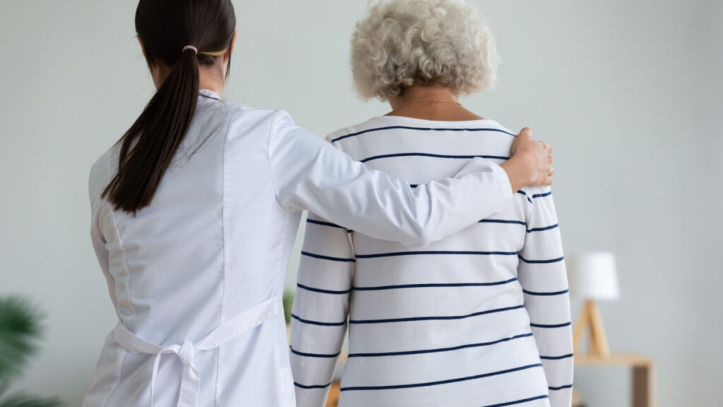 Doctor with arm around patient. Representing the Preferred Home Care and AssistCare data breach class action lawsuit settlement