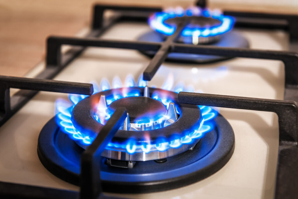 Closeup shot of blue fire from LG kitchen stove top, representing the LG gas stove class action.