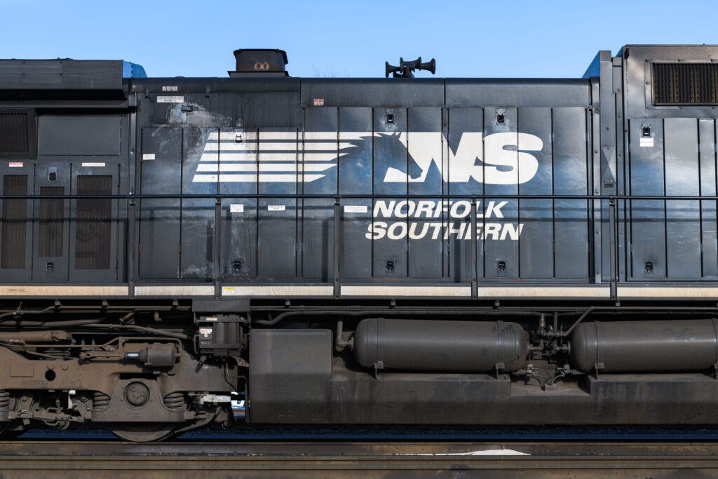 Closeup view of name and logo on Norfolk Southern diesel locomotive, 