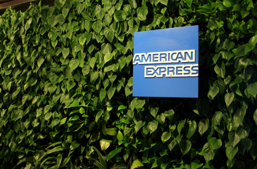 American Express logo on bushy wall