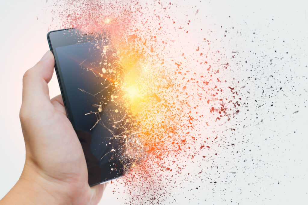 A person holding an exploding cell phone
