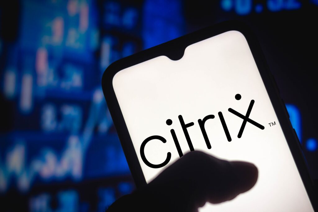 A thumb touches a smartphone that reads "Citrix" on the screen, representing the Citrix TCPA class action lawsuit settlement.
