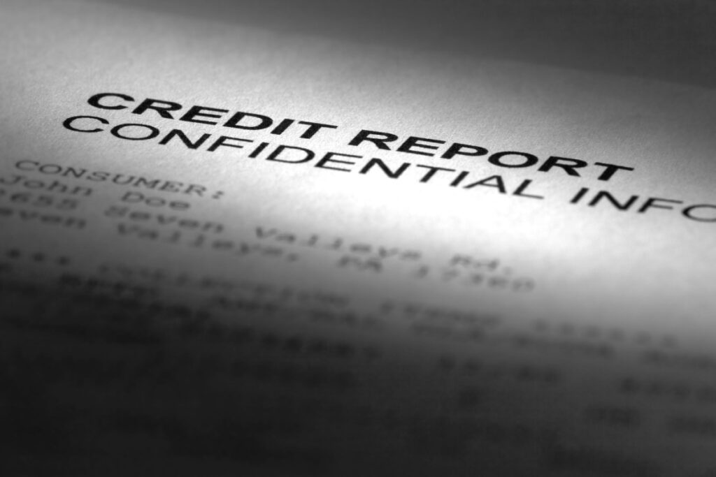 A paper that reads "Credit Report, Confidential",representing the Preferred Precision Group class action lawsuit settlement.