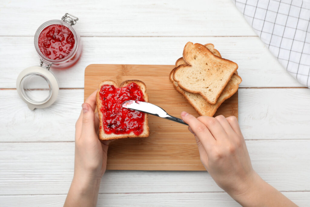 A person spreading jam onto a piece of bread, representing the Polaner spreads class action