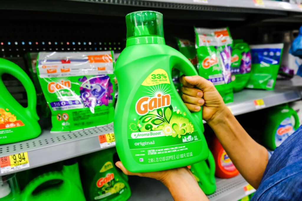 A person holding Gain laundry soap