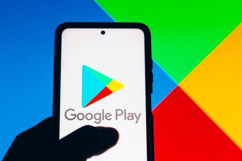 Google play logo on cellphone representing the Google Play app developer class action lawsuit settlement.