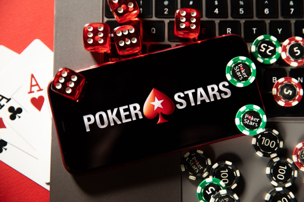 PokerStars logo on cellphone with gambling chip around the phone, representing the PokerStars SEC fine over Russian poker legalization vioaltions.