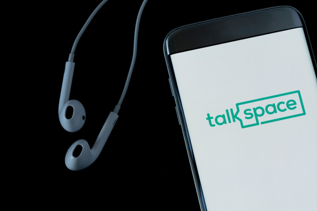 Headphones next to cellphone with TalkSpace logo