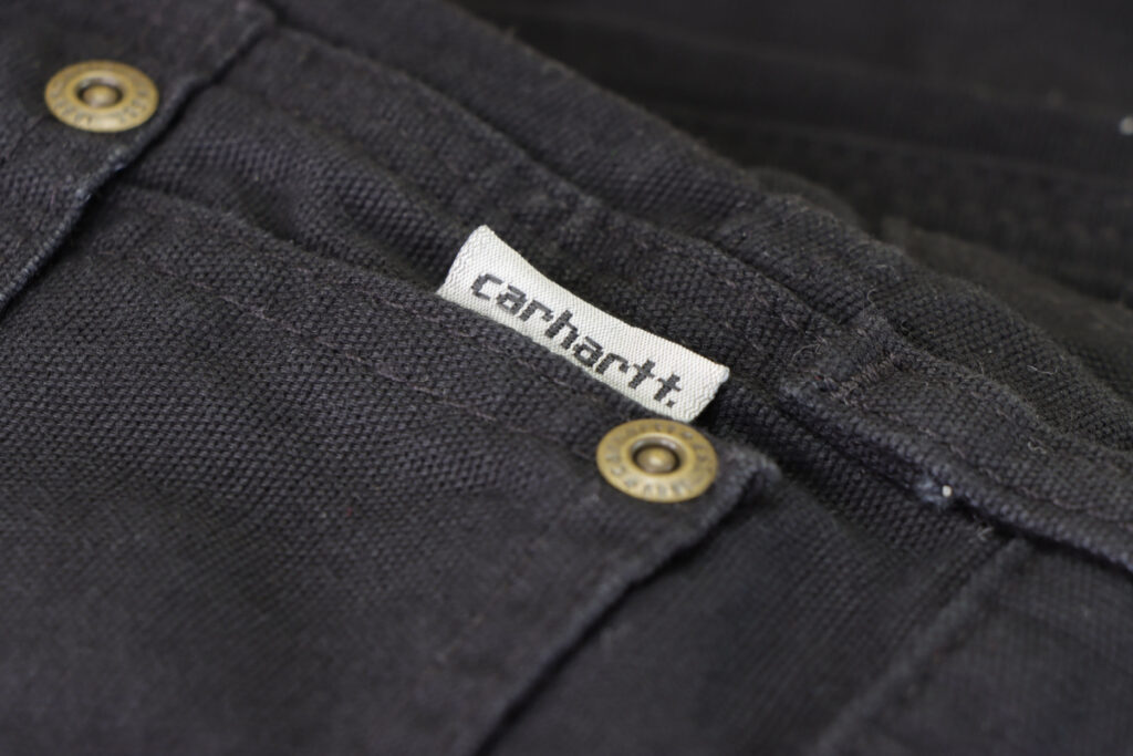 Close up shot of pants with Carhartt label