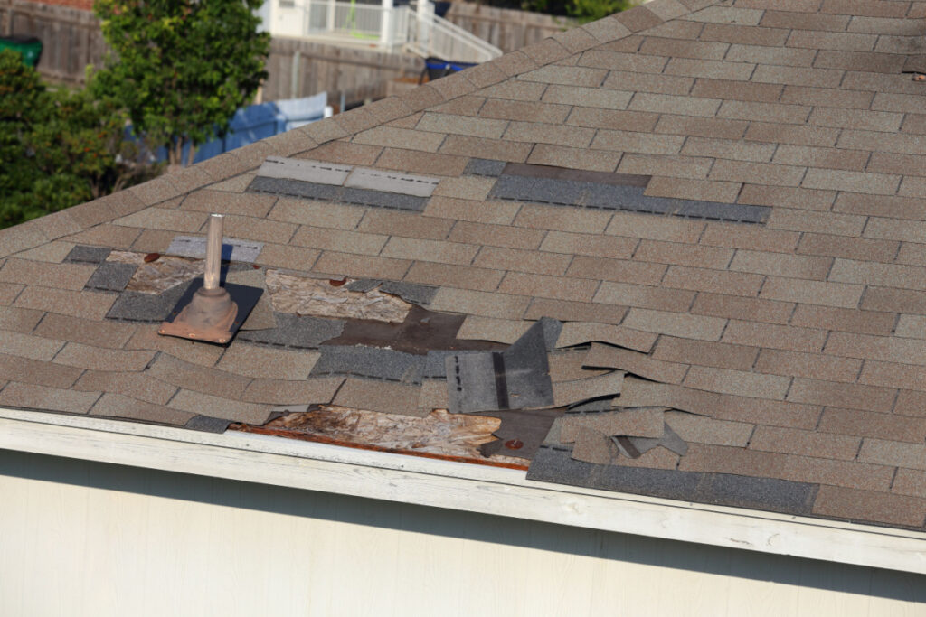 Broken shingles on home representing the CertainTeed settlement. The deadline to file a claim in the class action lawsuit settlement is March 2, 2030.