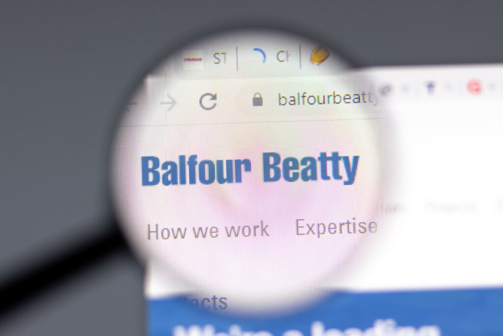 A magnifying glass looking at Balfour Beatty website landing page representing the Balfour Beatty settlement.