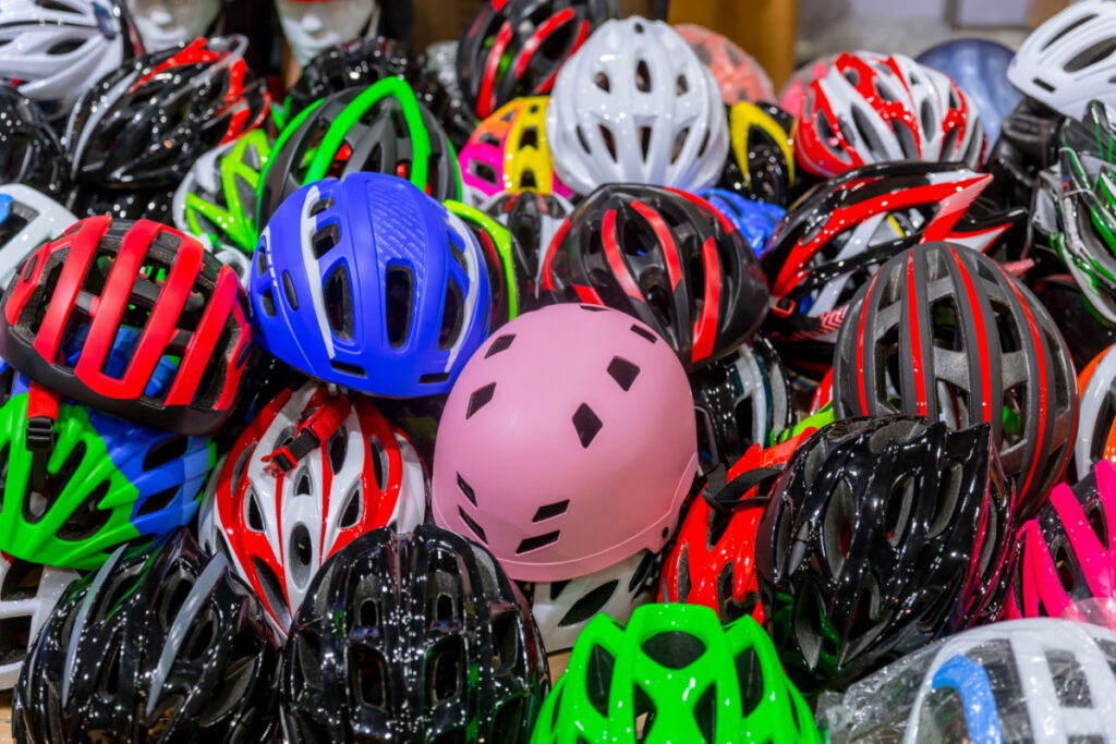 Multiple bike helmets in a large pile