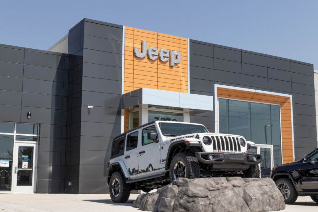 Jeep in front of a Jeep sign at the dealership, representing the fuel pump class action