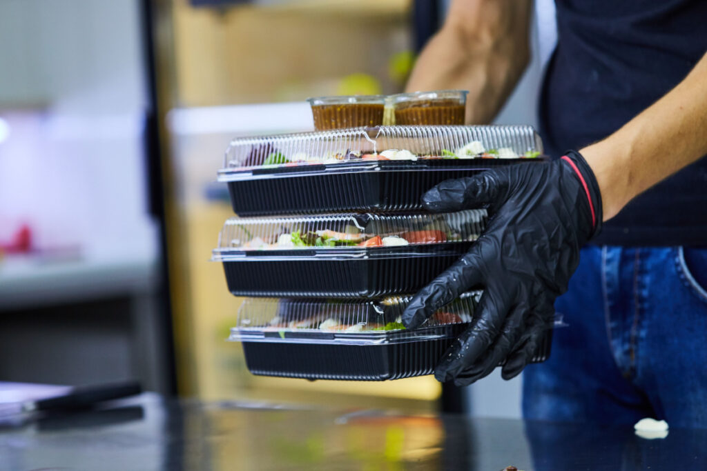 A food service employee will have 3 salads in to-go boxes