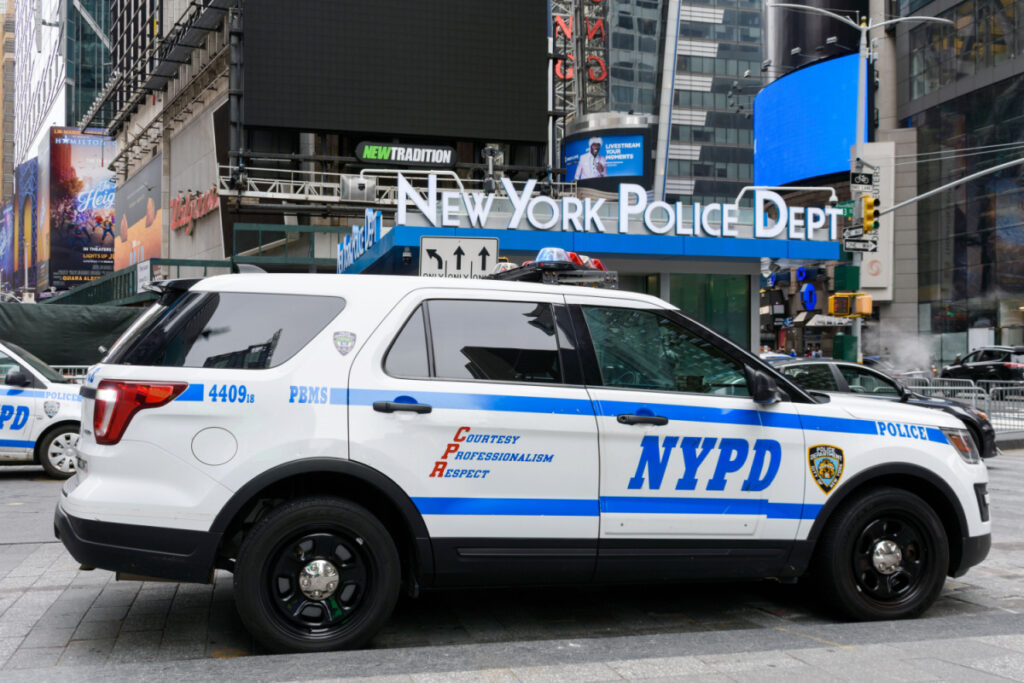 New York City police SUV in front of a New York City police station, representing the DNA database lawsuit