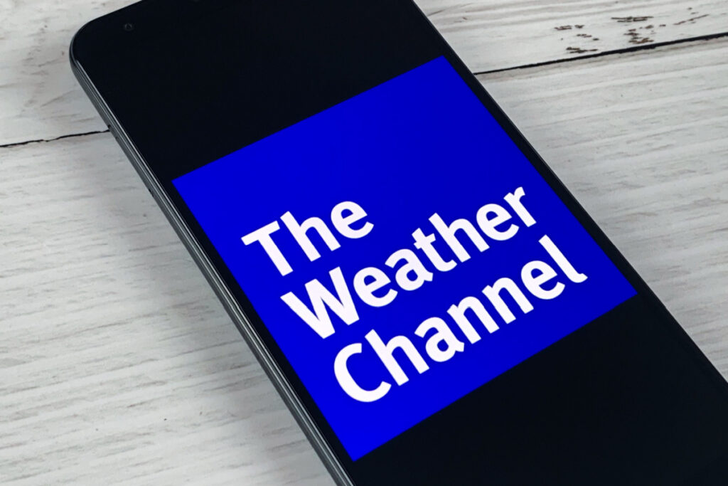 Smartphone showing The Weather Channel application logo on an a screen.