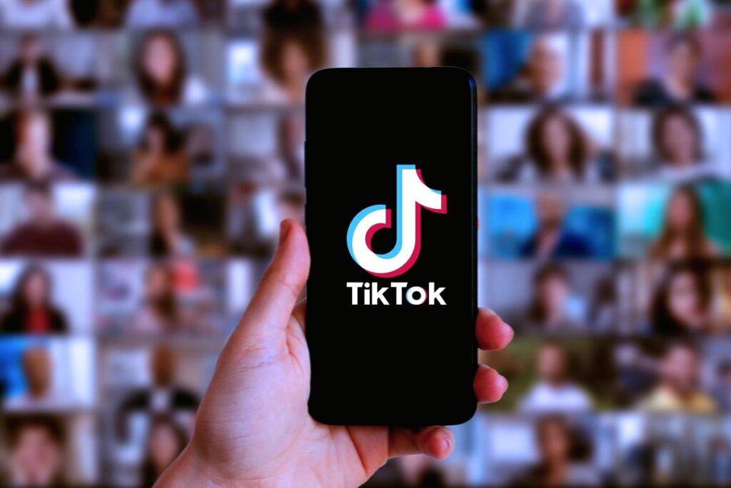 Close up of a hand holding a smartphone with the TikTok logo displayed, representing the Montana TikTok ban.