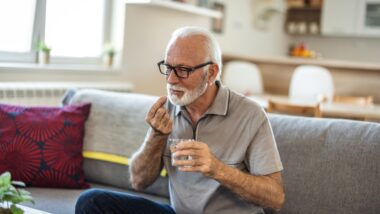 man with glass of water taking pill at home, This investigation involves individuals who may have a claim against drug manufacturers if they took Zantac or ranitidine and later developed certain cancers.