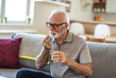 man with glass of water taking pill at home, This investigation involves individuals who may have a claim against drug manufacturers if they took Zantac or ranitidine and later developed certain cancers.