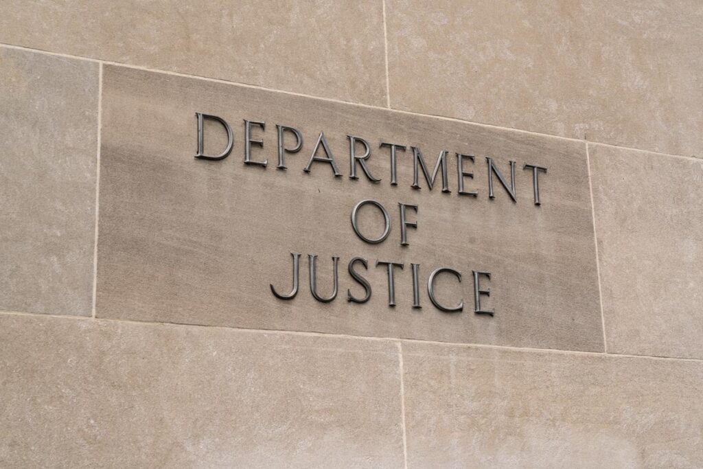 Close up of Department of Justice signage, representing the ex-Apple employee indictment.