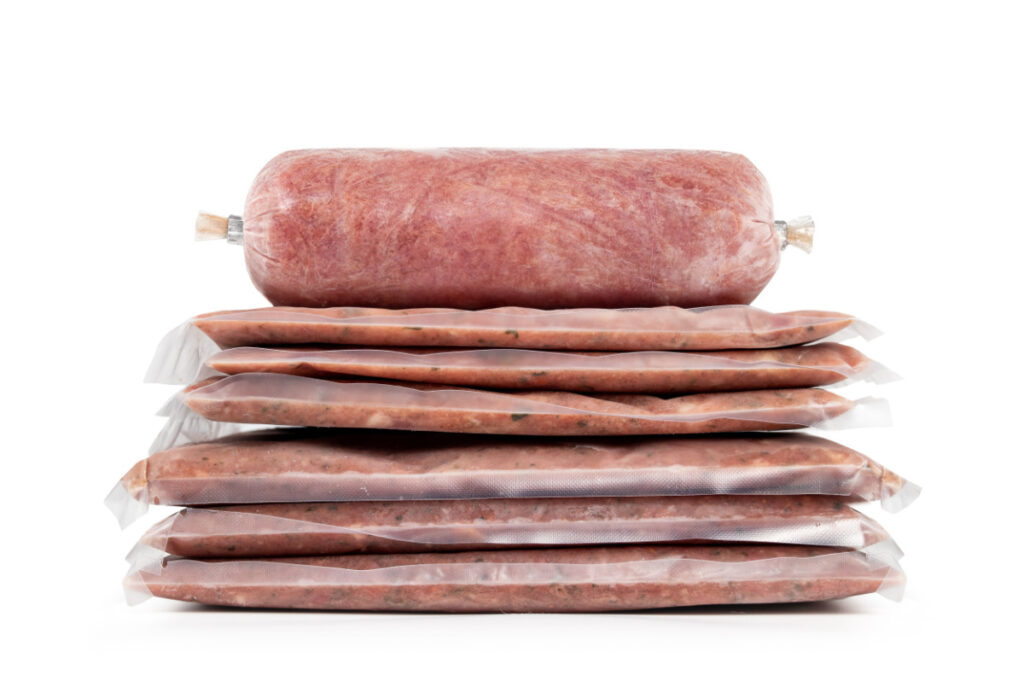 Raw homemade sausage in natural casing isolated on white background.