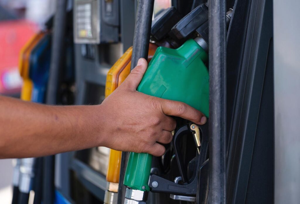 Close up of a persons hands holding a gas pump, representing the Love’s gas station class action.