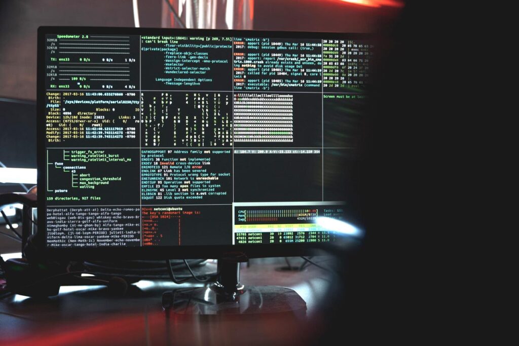 Hooded hacker hacking, representing the dental data breach.