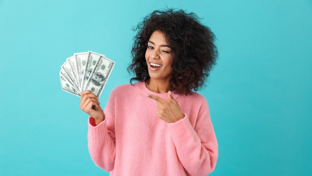 Happy woman with money in hand