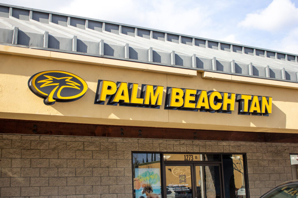 Close up of Palm Beach Tan signage on a building, representing the Palm Beach Tan text messages class action.