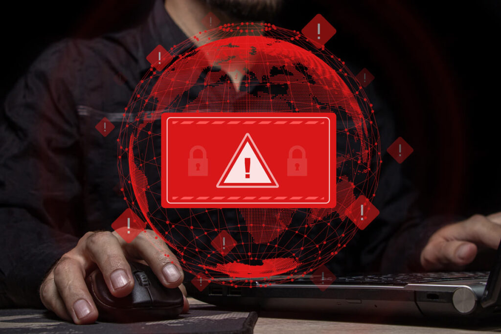 Close up of a man using a computer with a data breach concept overlay, representing the Carrington, Alvaria sales breach.