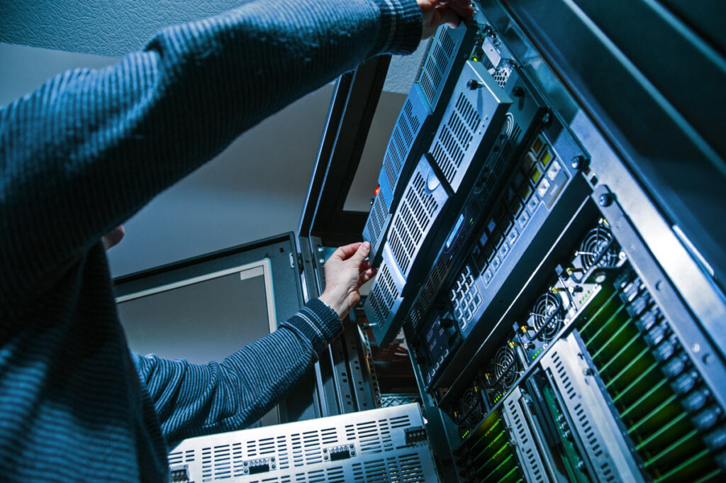 An operator fixing a data server, representing the Minnesota Department of Education data breach.
