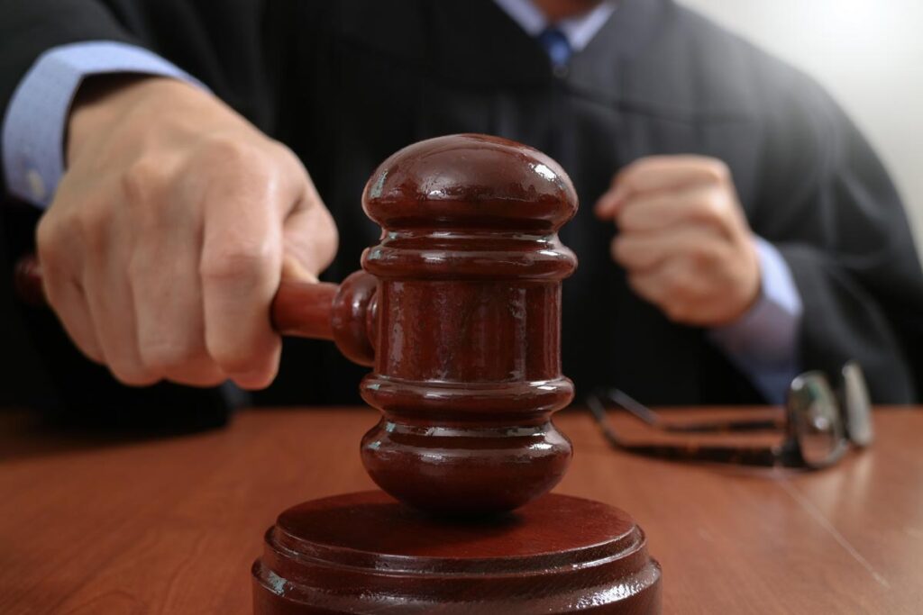 Close up of a judges hand striking a gavel, representing the South Carolina abortion ban.