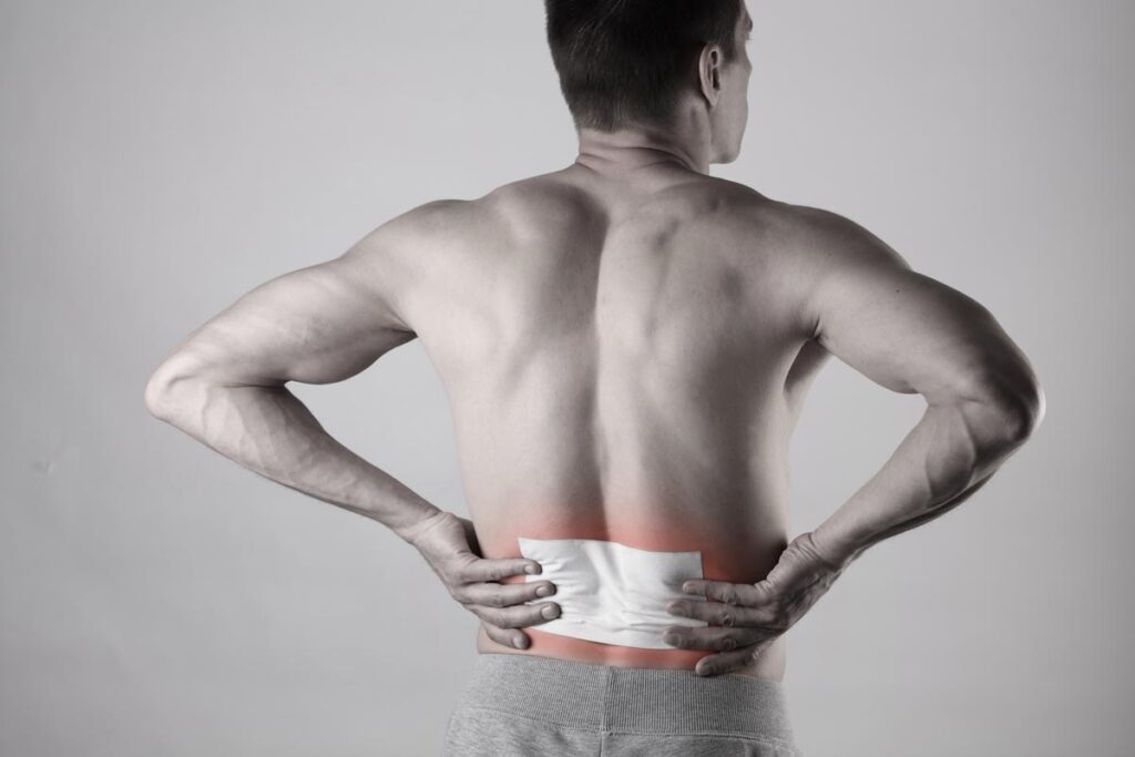 A male with a lidocaine patch on his lower back, representing the Quality Choice lidocaine patches class action lawsuit.
