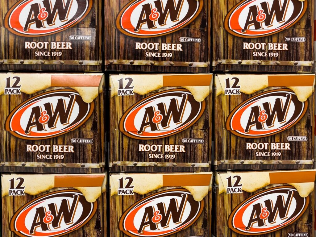 Cases of A&W root beer are seen stacked, representing the A&W class action lawsuit settlement.
