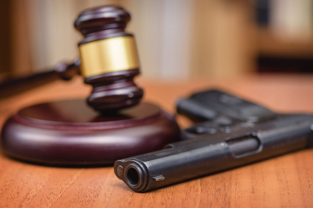 Close up of gun and gavel, representing the Supreme Court domestic violence gun case.